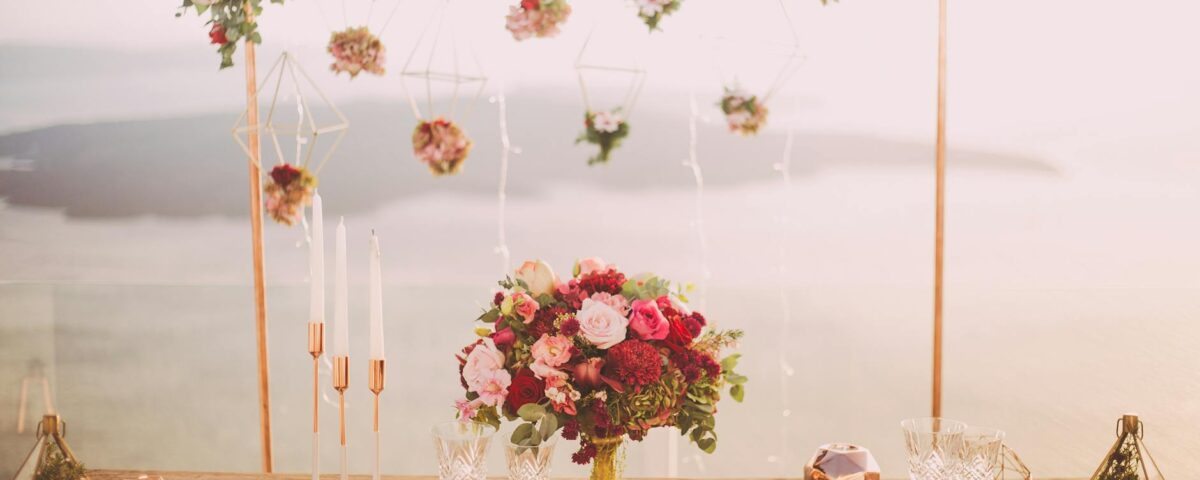pink and red roses centerpiece near silverwares