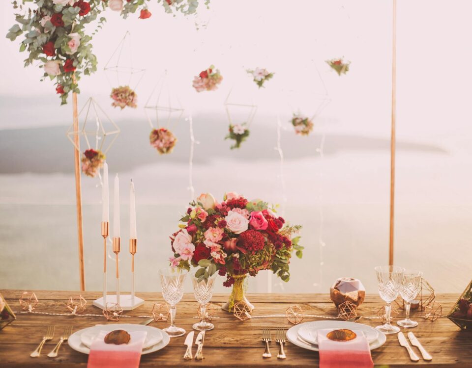pink and red roses centerpiece near silverwares